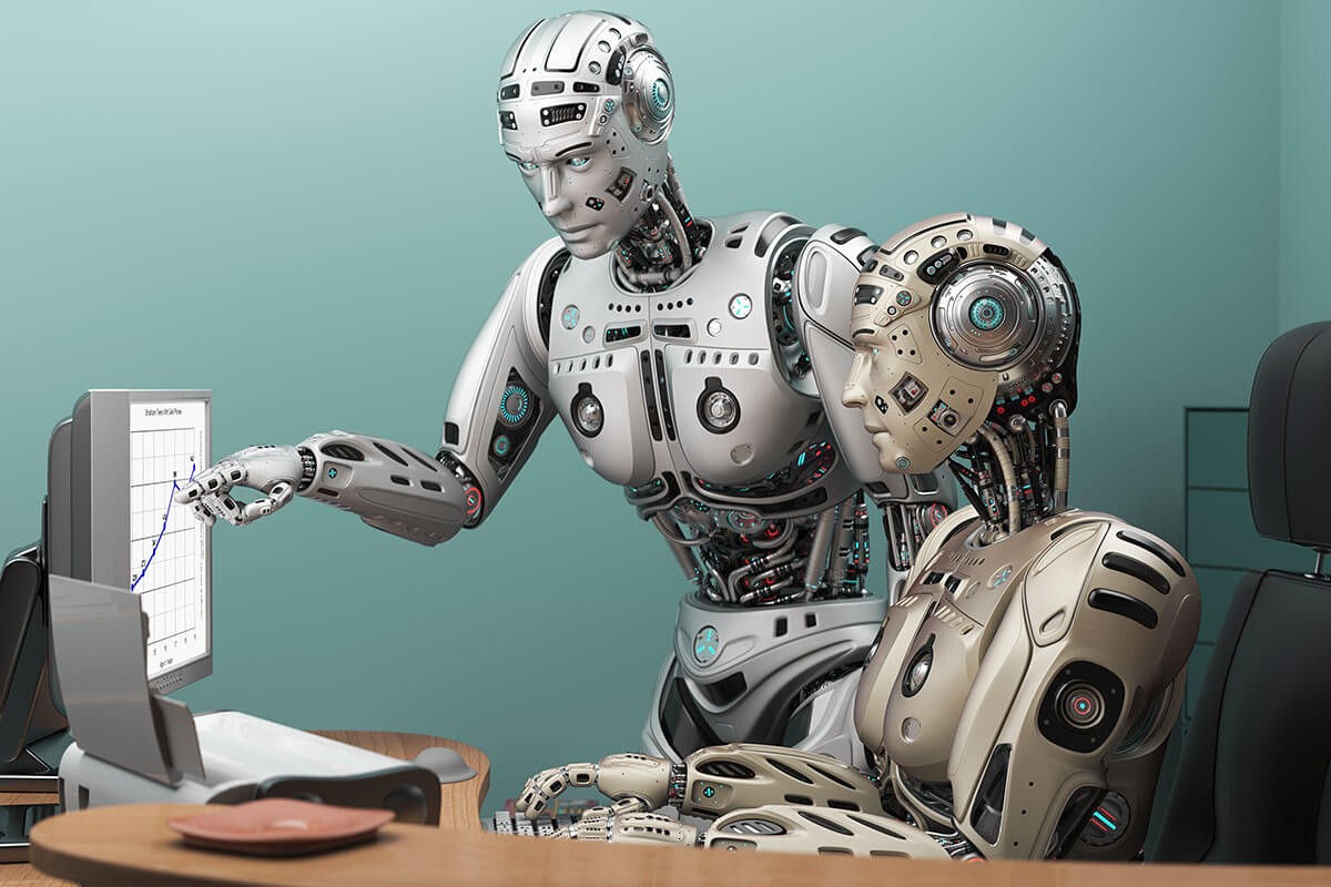 Two robots are looking at a computer monitor