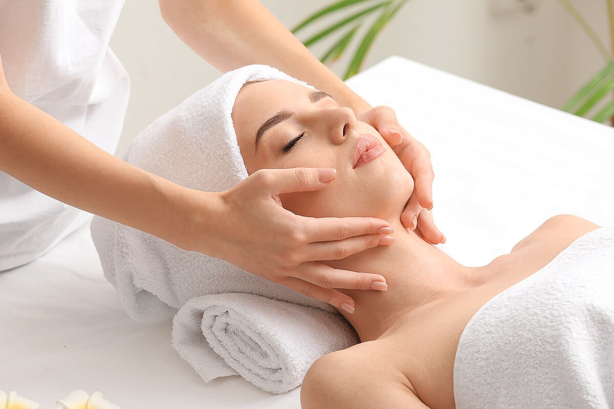 A woman lies and is given a massage against facial wrinkles A woman lies and is given a massage against facial wrinkles