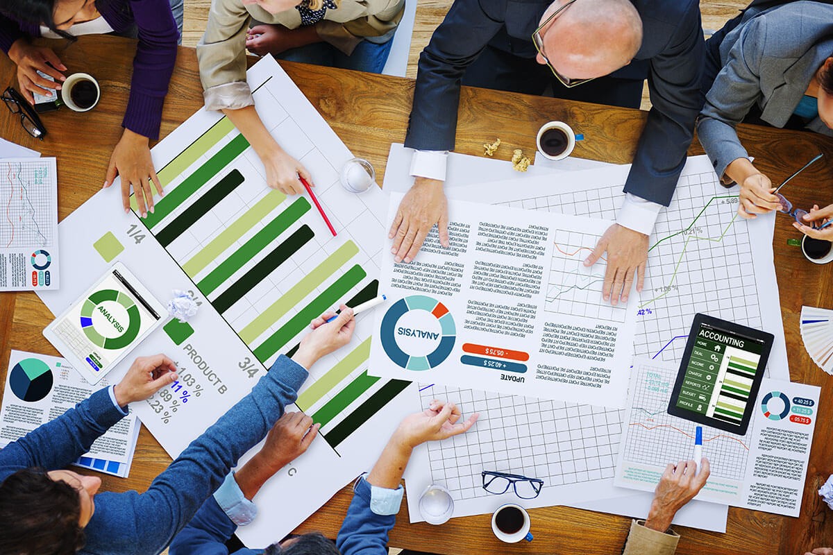 Men and women analyze statistics at the table