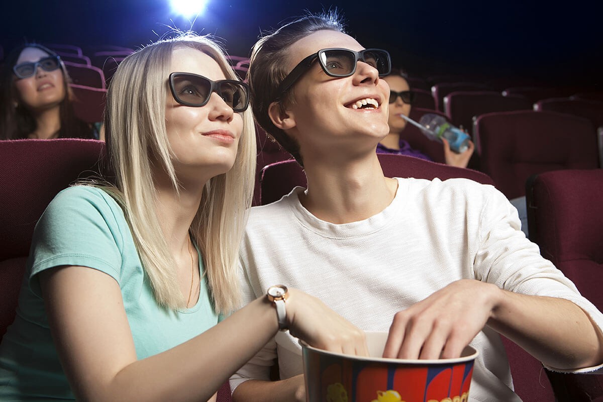 Male and female watching a movie together