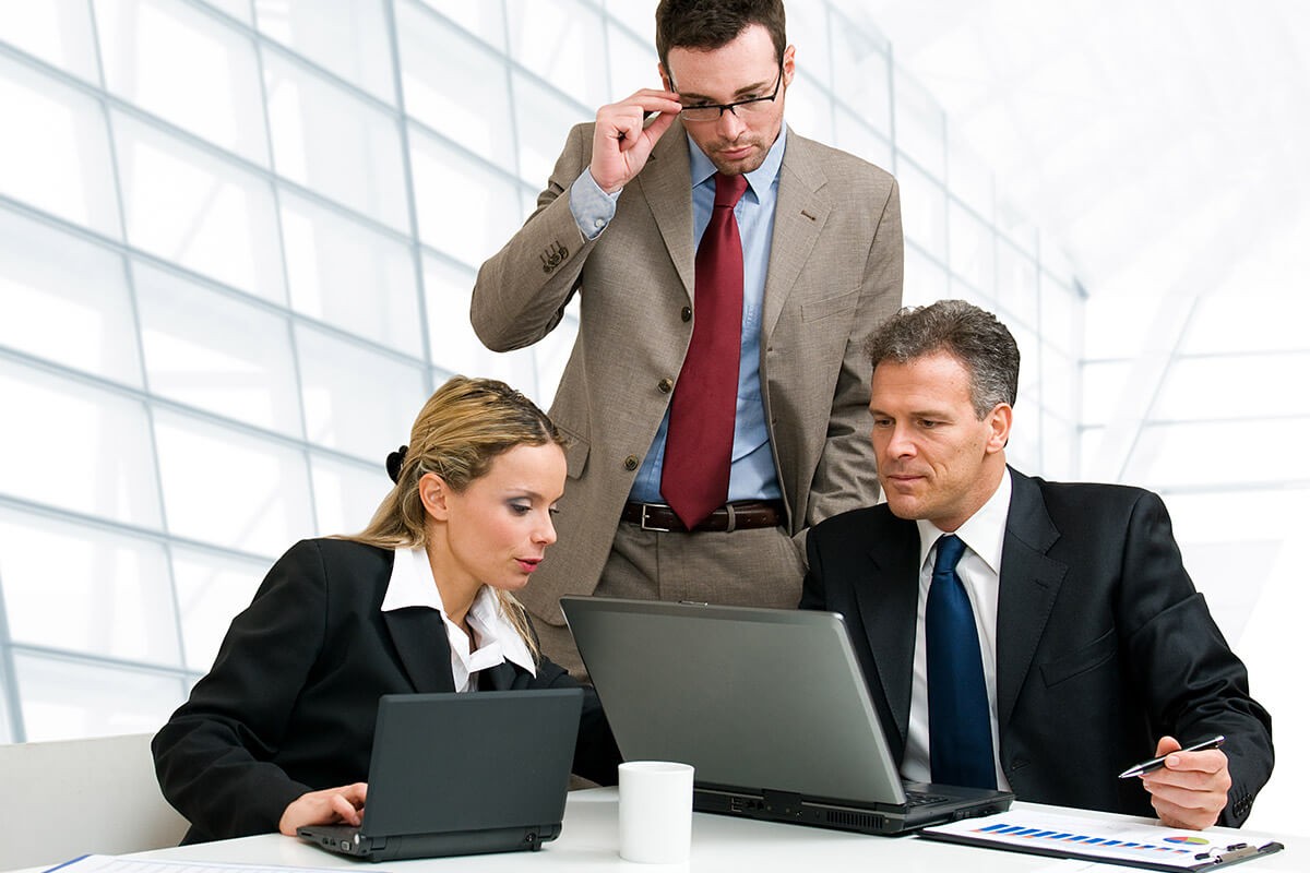 Business men and woman with laptops
