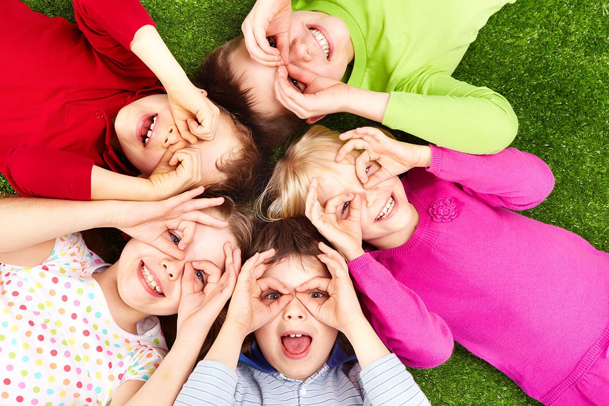 Joyful children lie on the ground