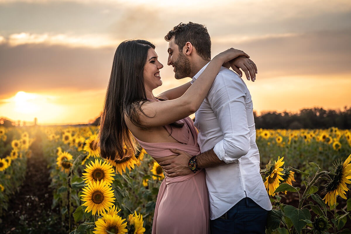 Loving couple hugging at sunset