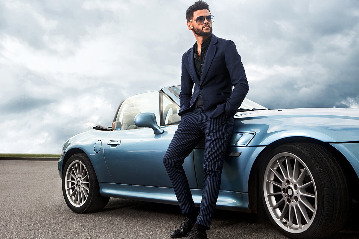 Rich man on an expensive sports convertible