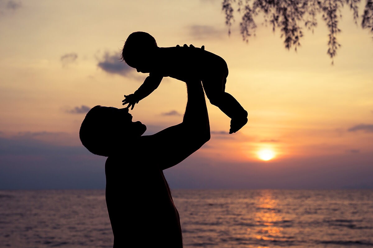 Father raises his child above his head