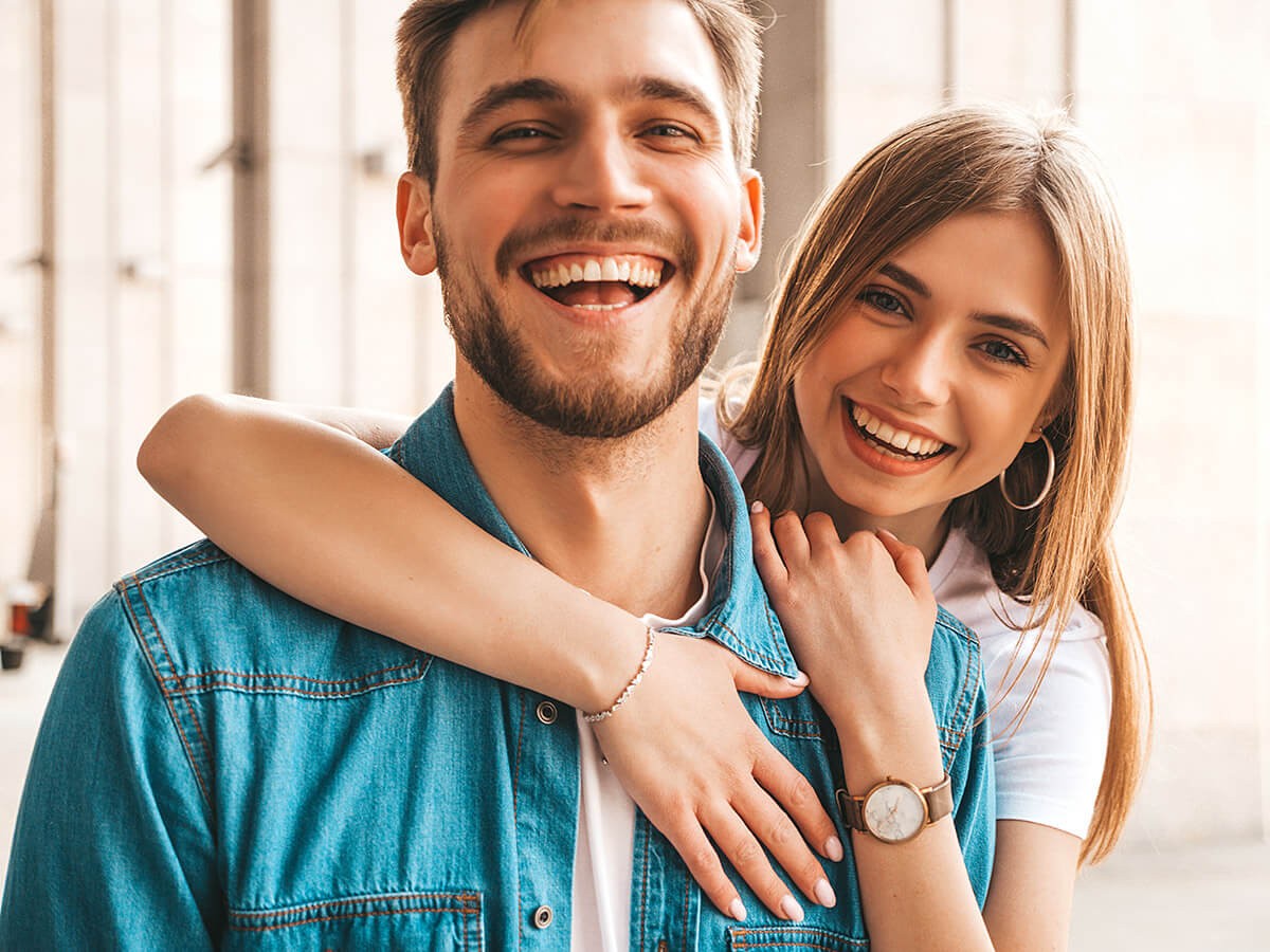 Happy young married couple laughing