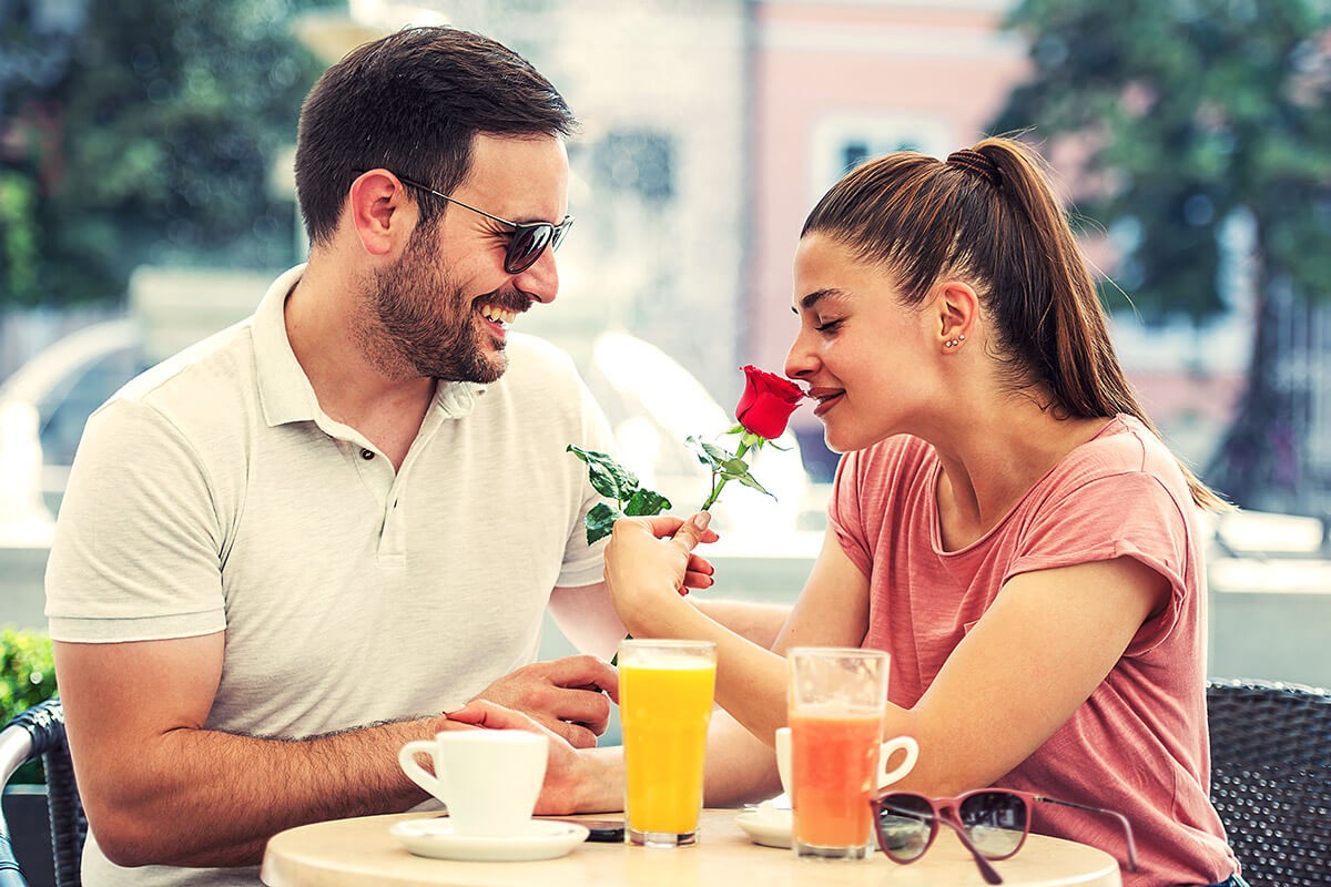 Husband gives flowers to his wife