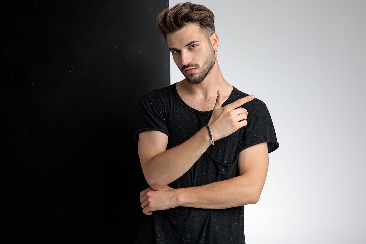 Charismatic young guy on a black white background Charismatic young guy on a black white background