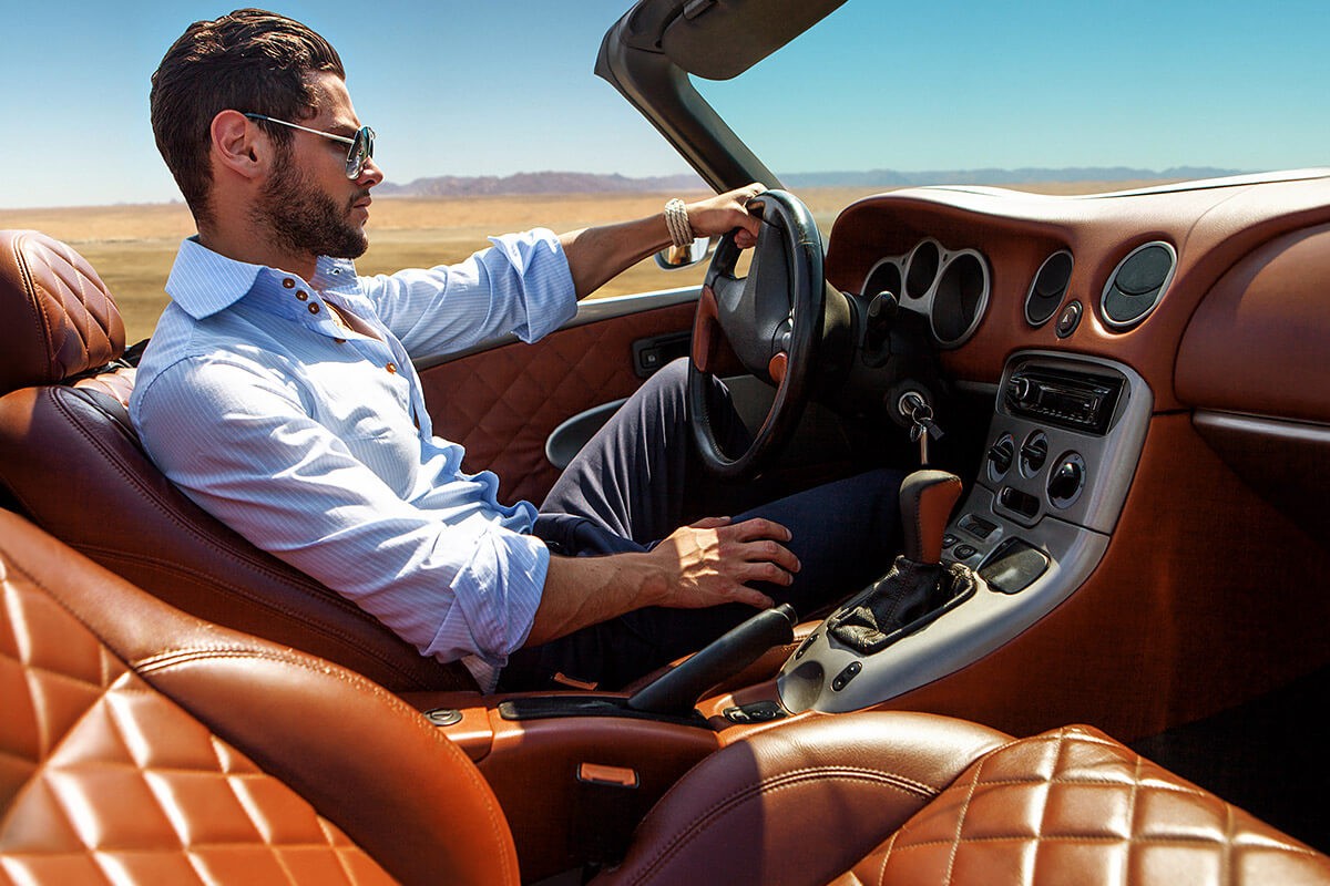 Wealthy guy driving an expensive convertible Wealthy guy driving an expensive convertible