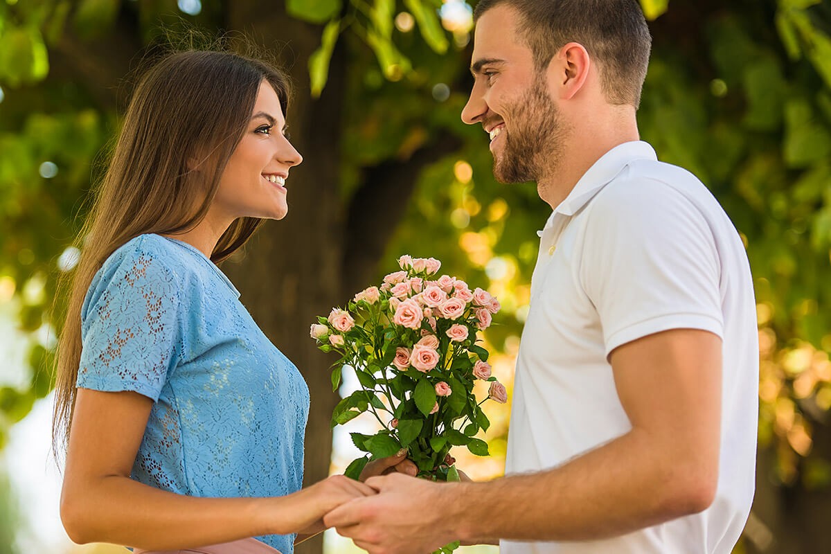 A man gives flowers to a woman and declares his love