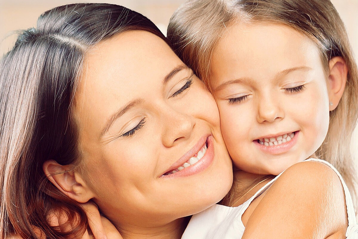 Mom hugs her beloved daughter tightly