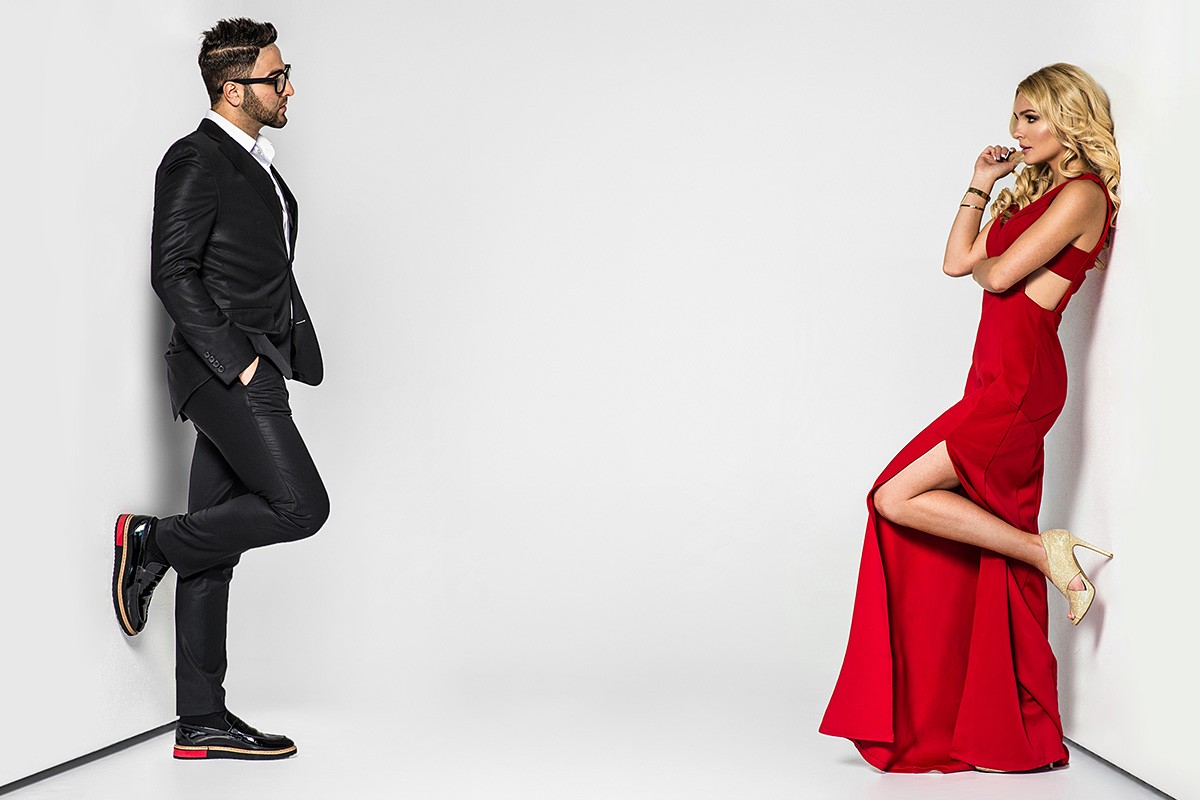 A man and a woman are standing opposite each other