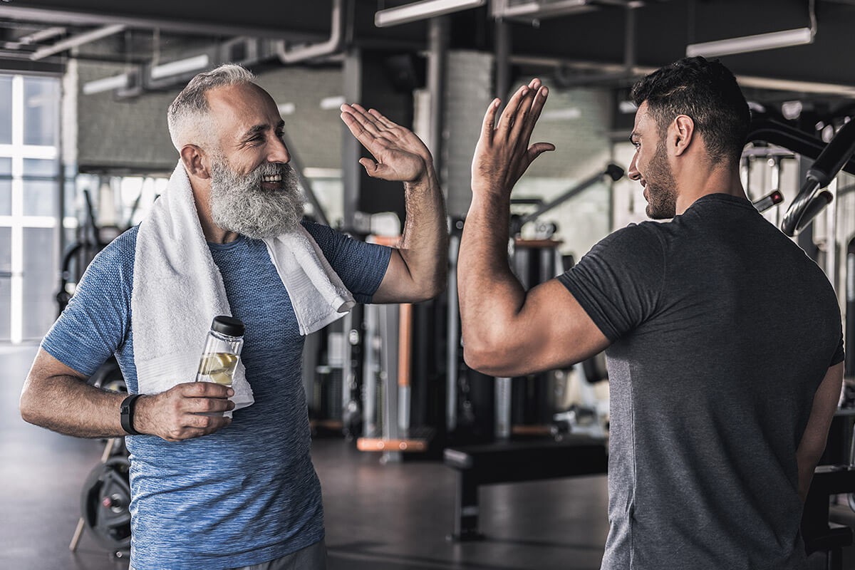 Male friendship of two men at the gym