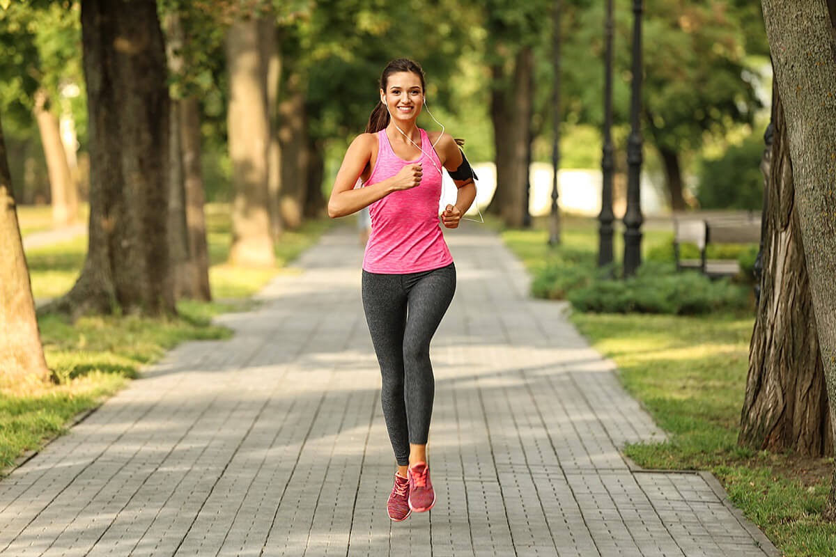 Woman goes in for sports - runs through the forest