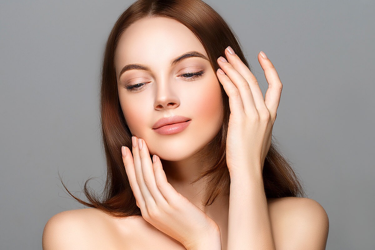 A woman shows the well-groomed face skin