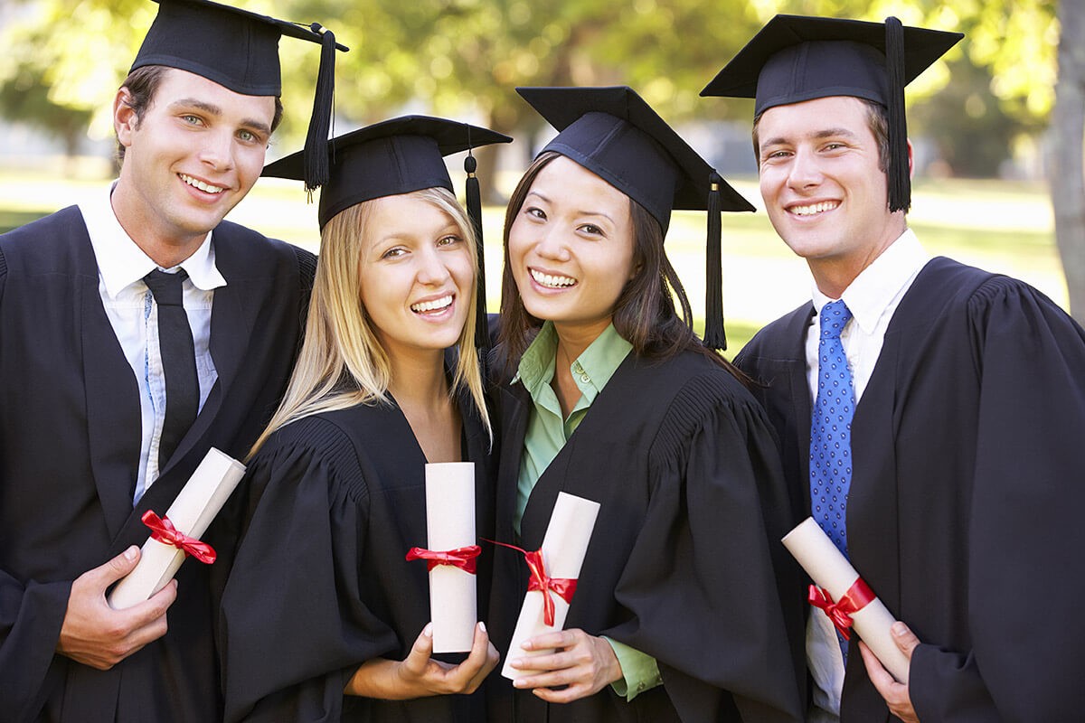Image of graduates with diplomas in their hands