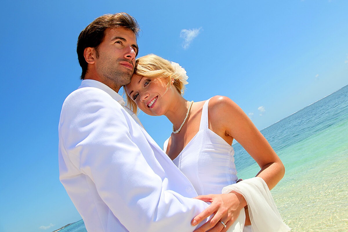 Romantic couple passionately hugging by the sea
