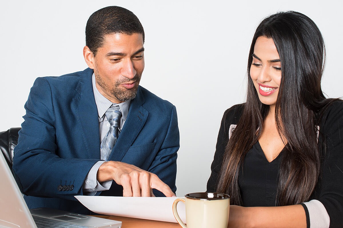 Image of man and woman reading together prenuptial agreement