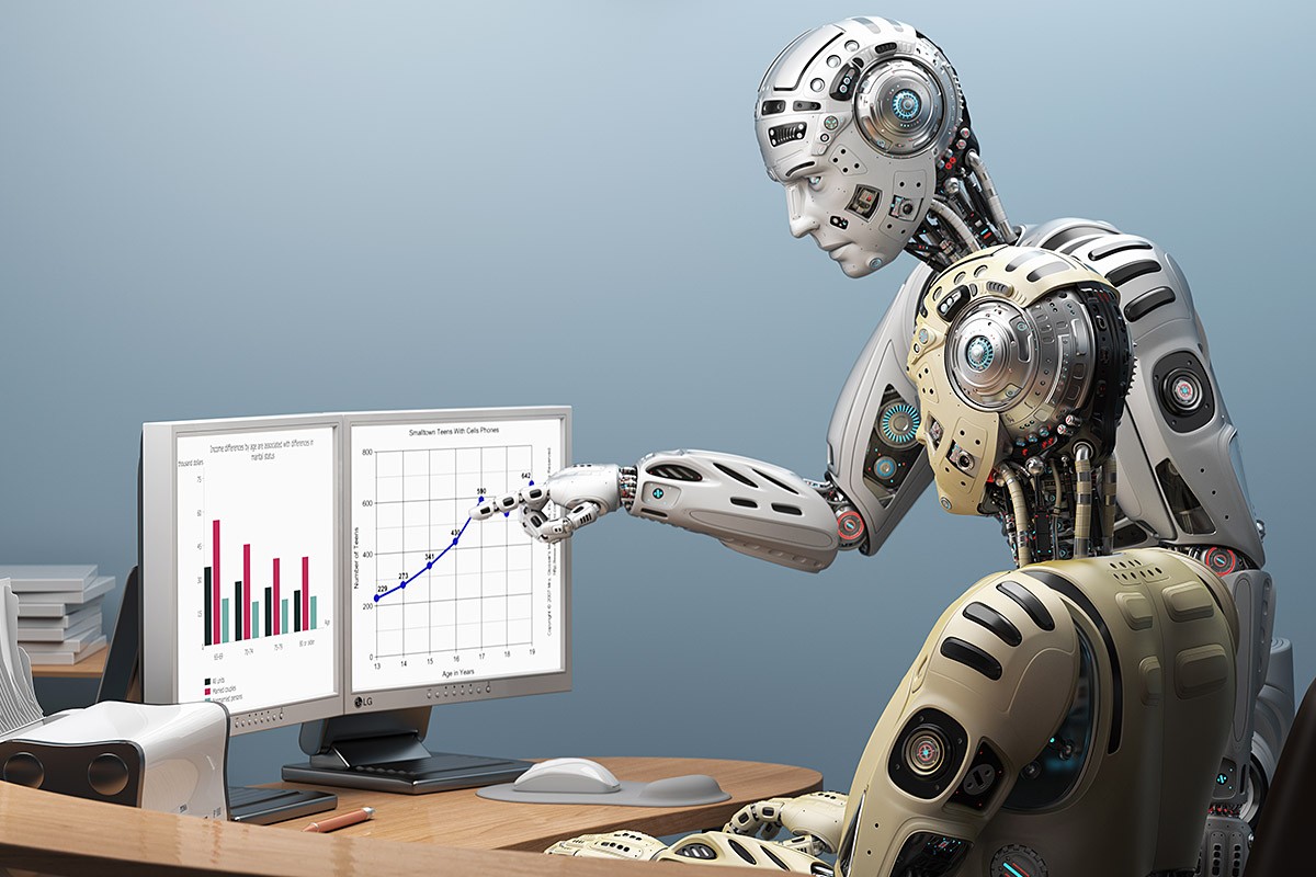 Image of two humanoid robots with a desktop computer