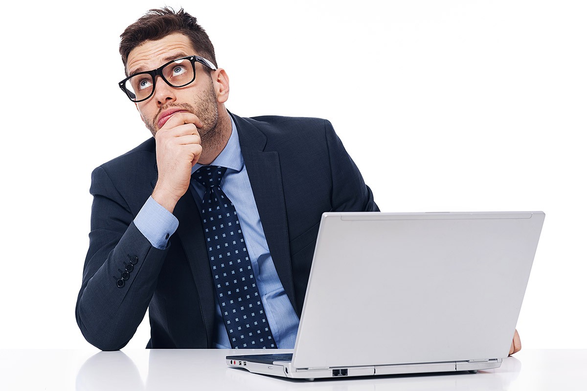 Pensive businessman with a computer