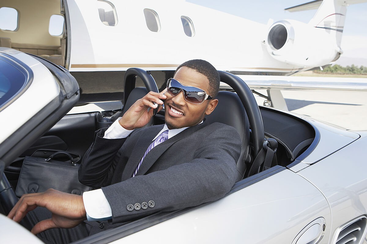 Rich man driving an expensive car