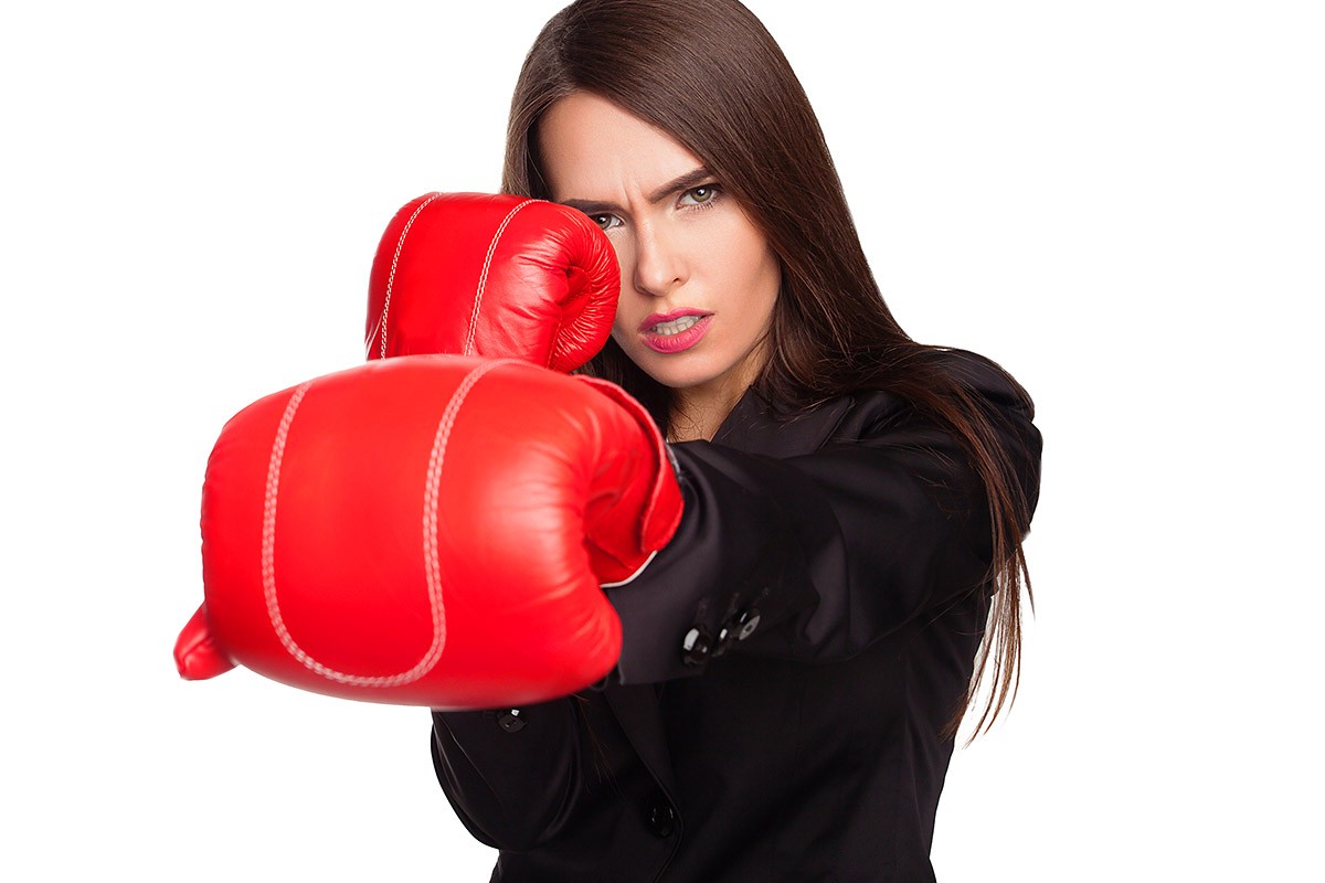 Business woman in boxing glove