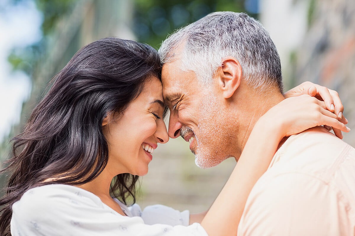 Woman gently hugs a man
