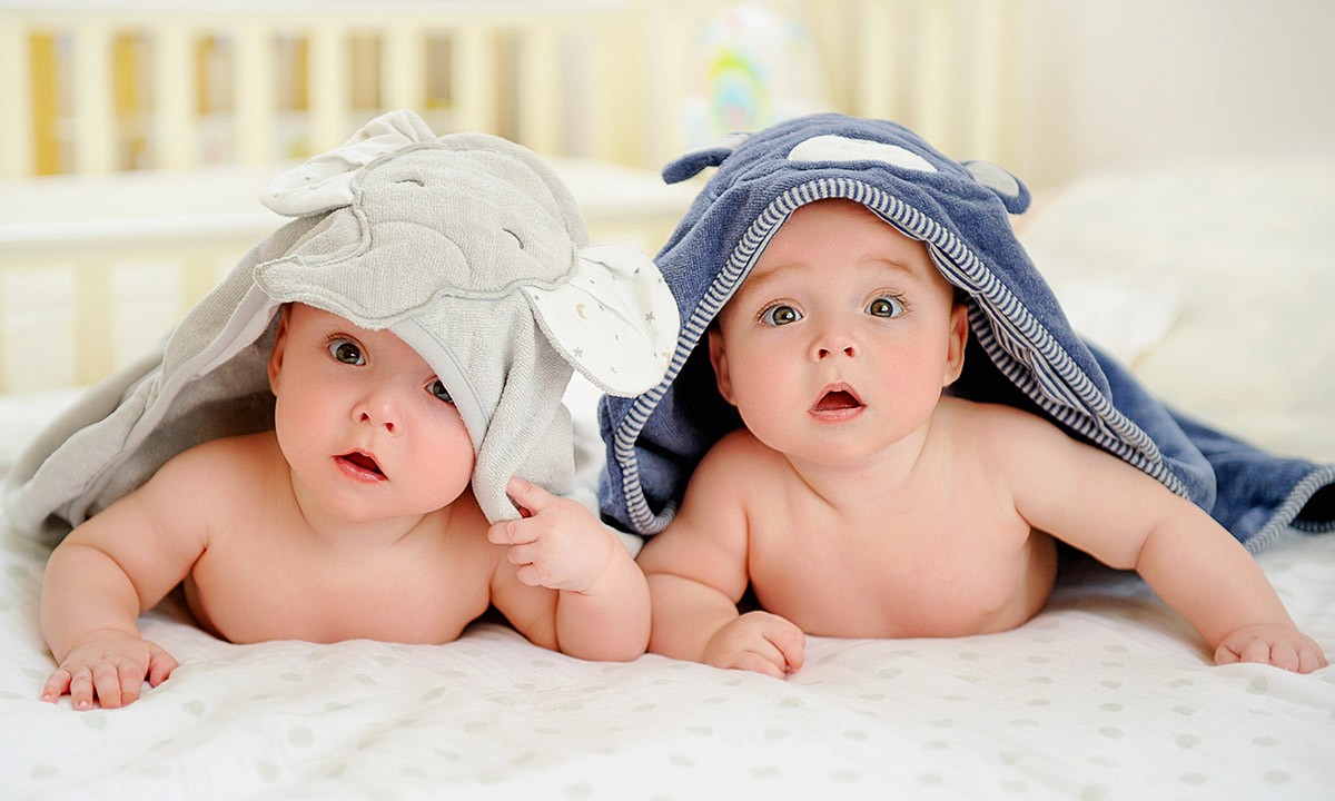 Image of two beautiful babies on the bed Image of two beautiful babies on the bed