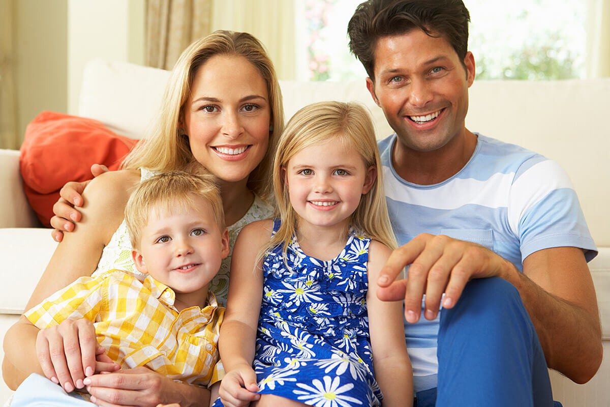 Image of a happy married couple and two children