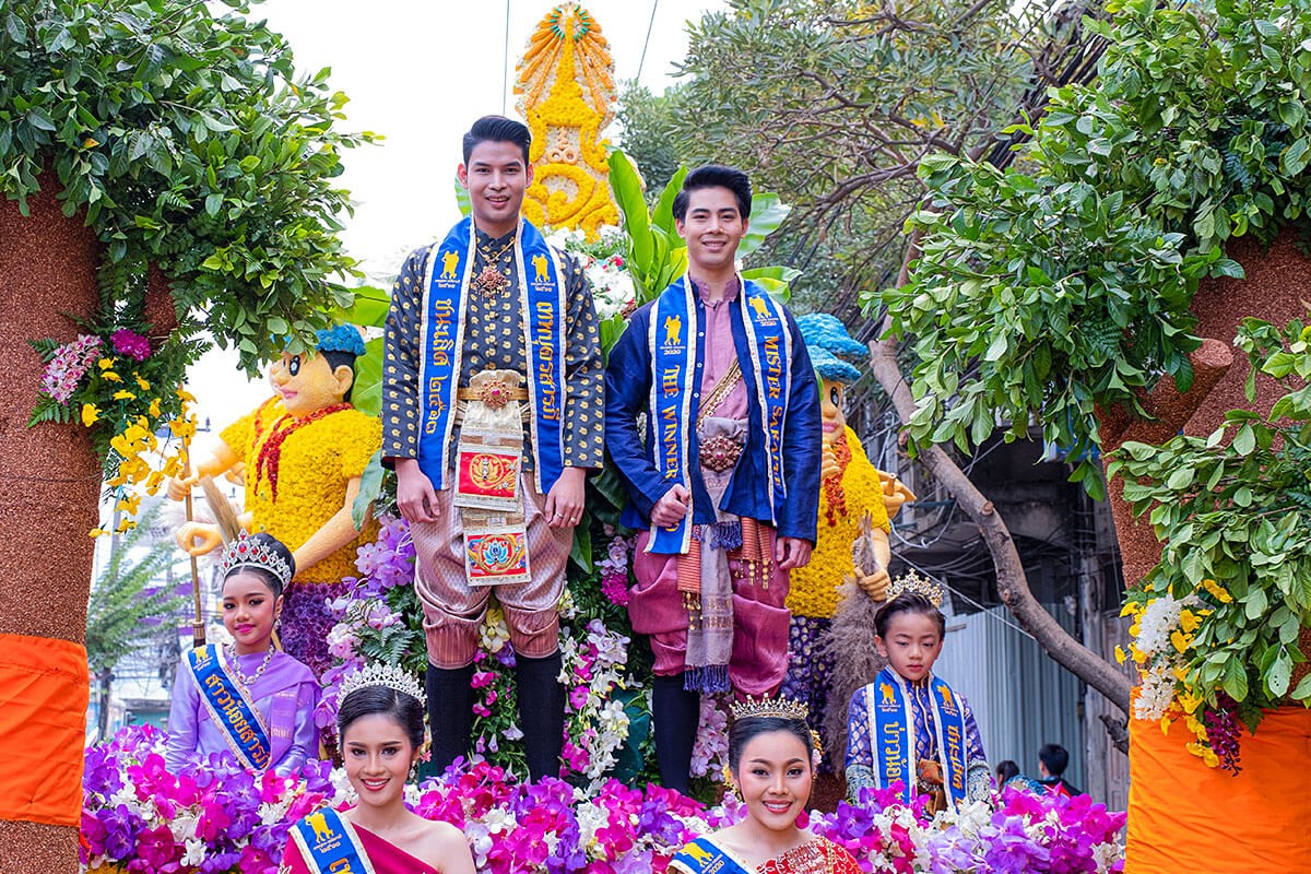 Image of men and women in traditional costumes and with flowers - Flower Festival, Thailand