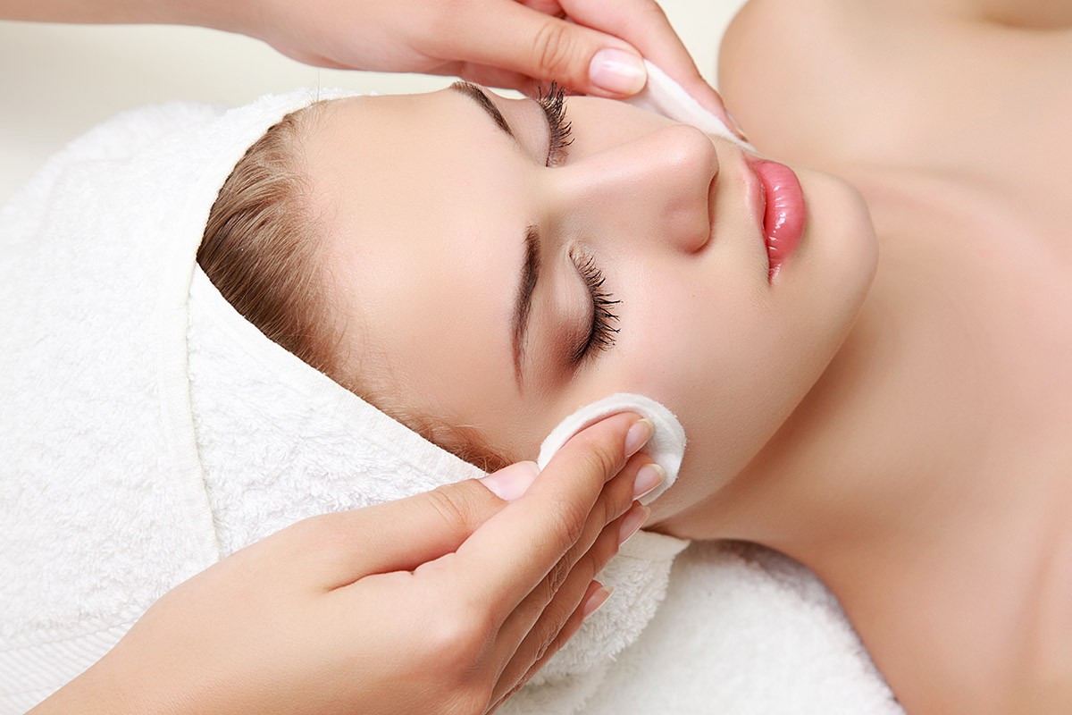 Image of a woman cleansing her face