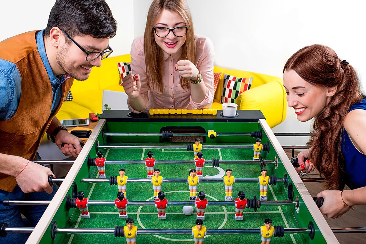 Girl and guy playing table football