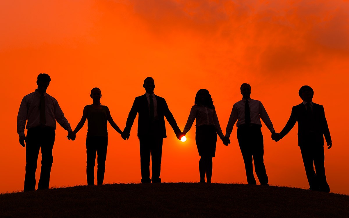 Image of a team of business people holding hands Image of a team of business people holding hands