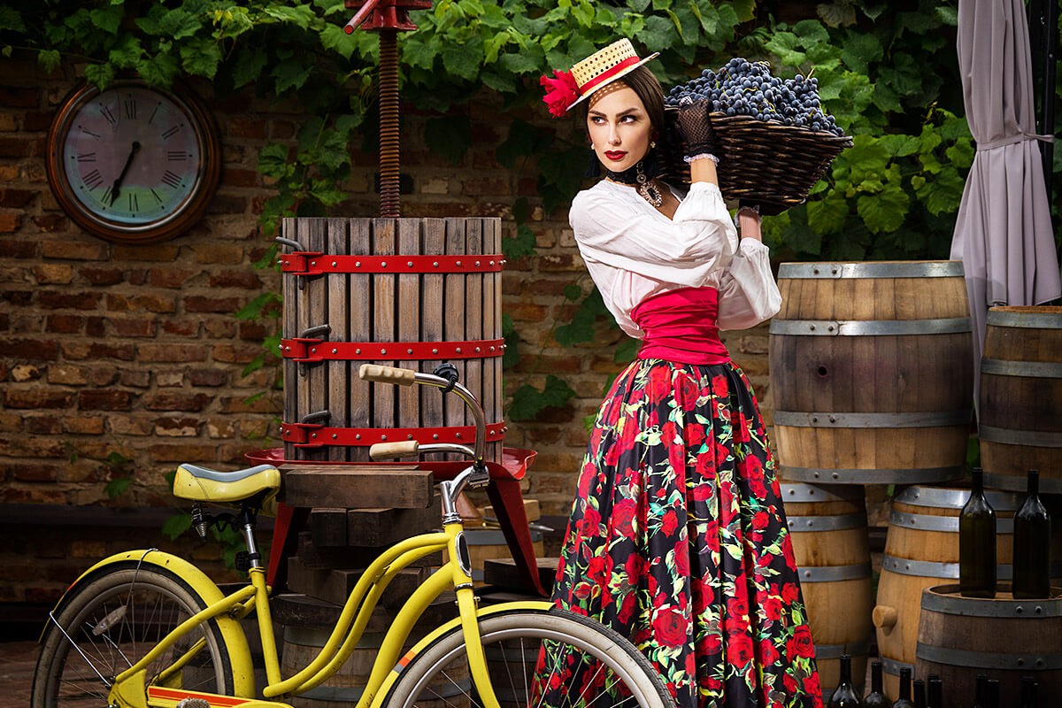 Image of a woman carrying a basket of grapes