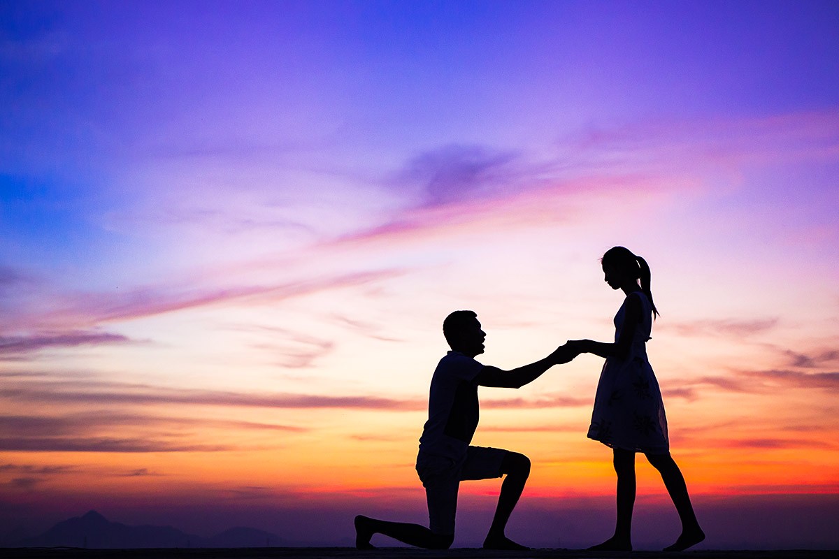 A man confesses his love to a girl at sunset A man confesses his love to a girl at sunset