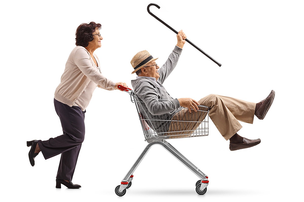 Image of grandmother taking grandfather on a grocery stroller