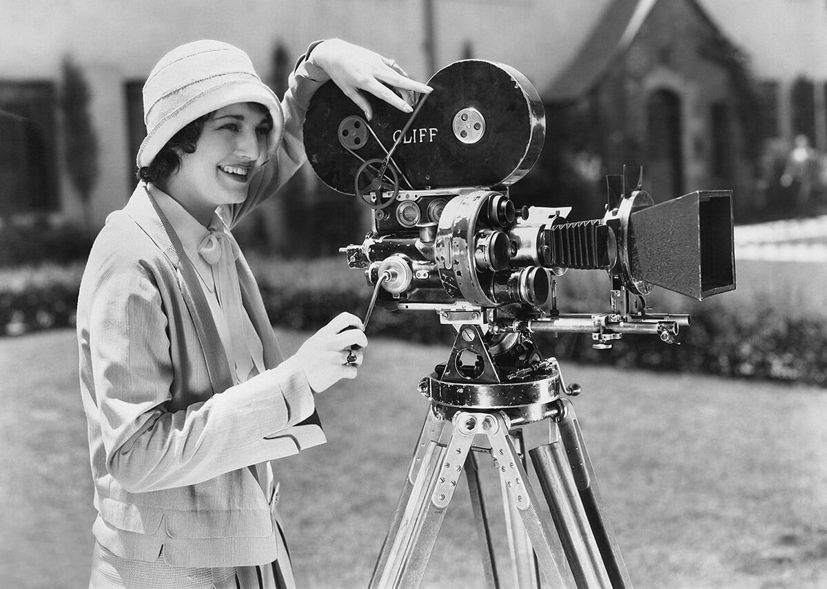 Historical image of a woman with an old camera