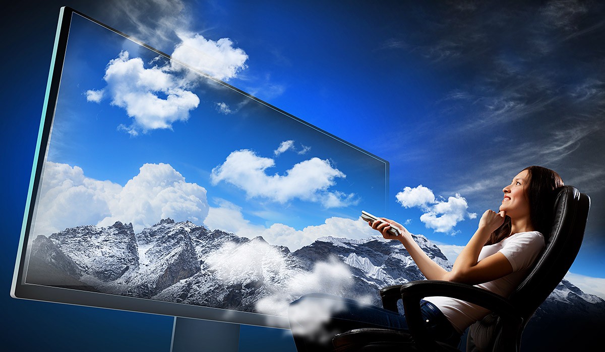 Young girl watching a movie on a large 3D TV