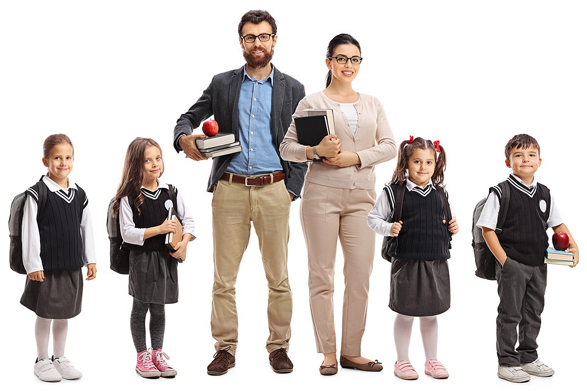 Image of two teachers with textbooks in their hands and next to their students