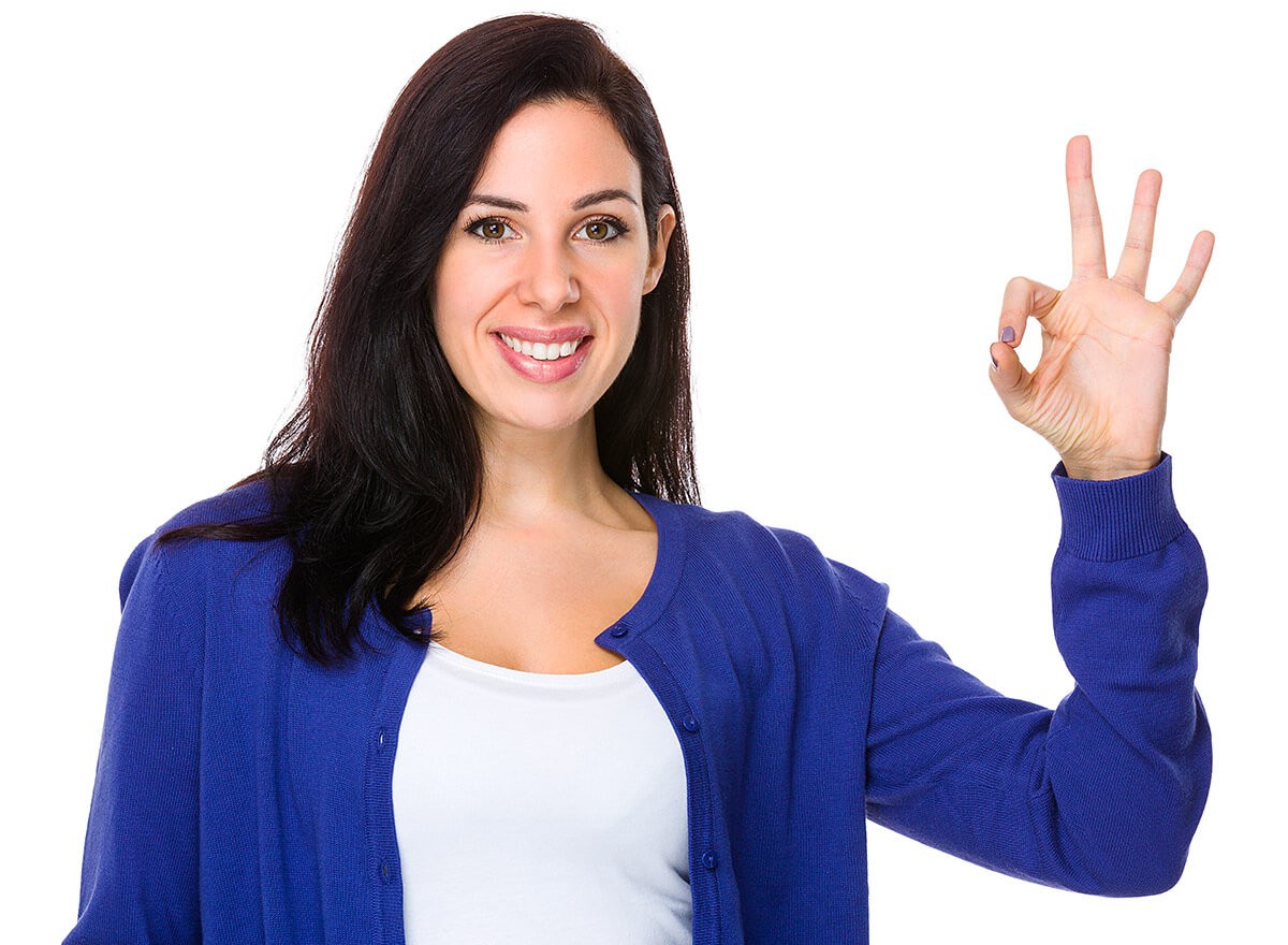 Image of a young girl who shows with her hand a sign all is well