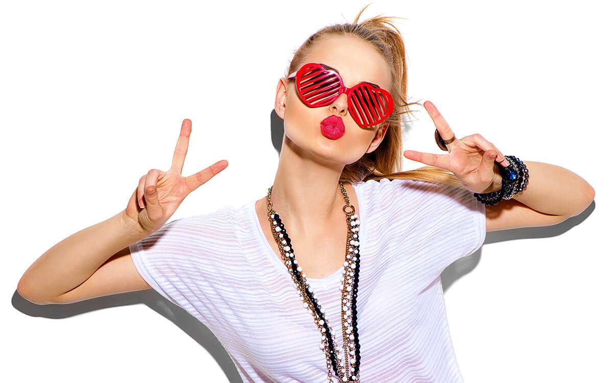Attractive girl in red glasses in the form of hearts Attractive girl in red glasses in the form of hearts