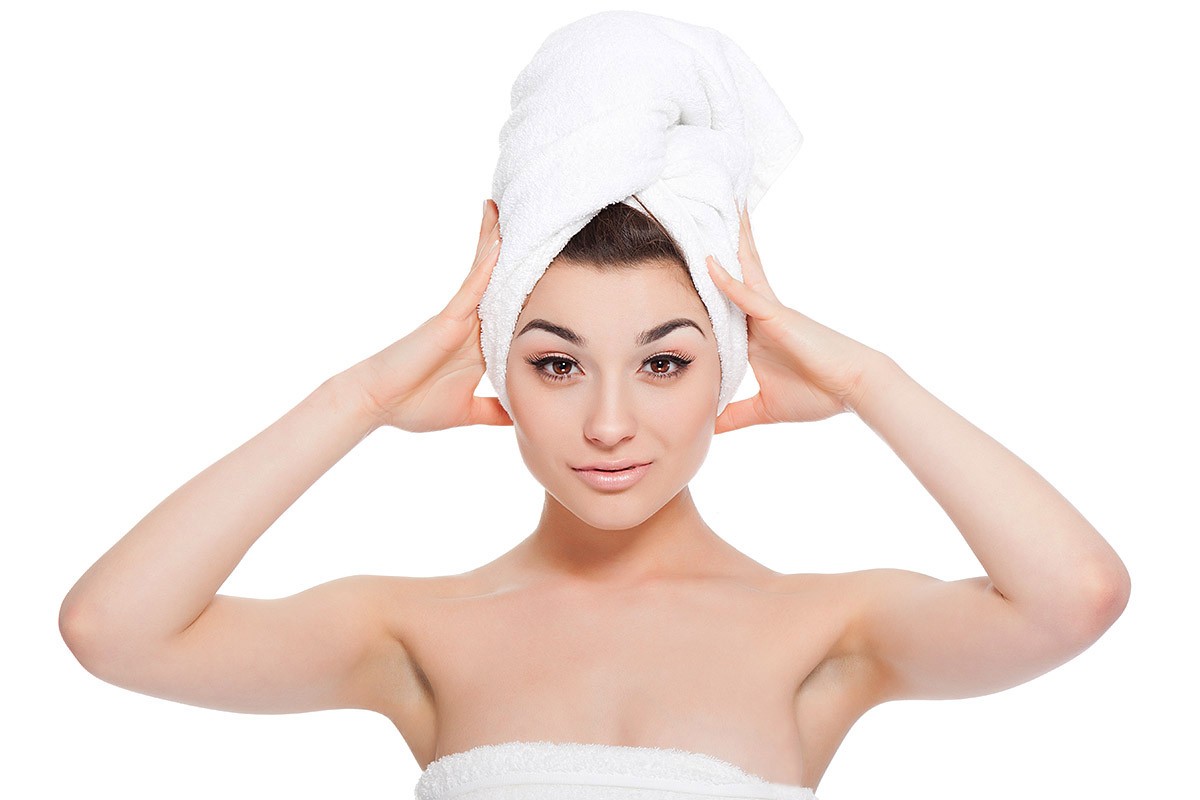 Woman dries hair with a towel Woman dries hair with a towel