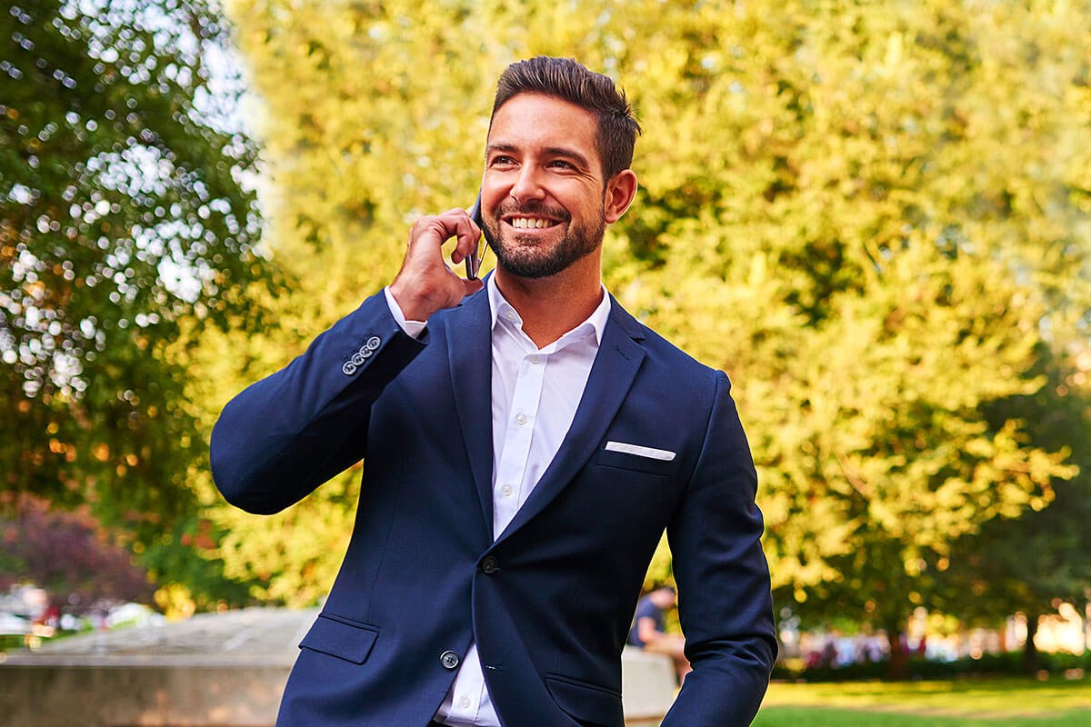 Entrepreneur in a business suit and with a mobile phone