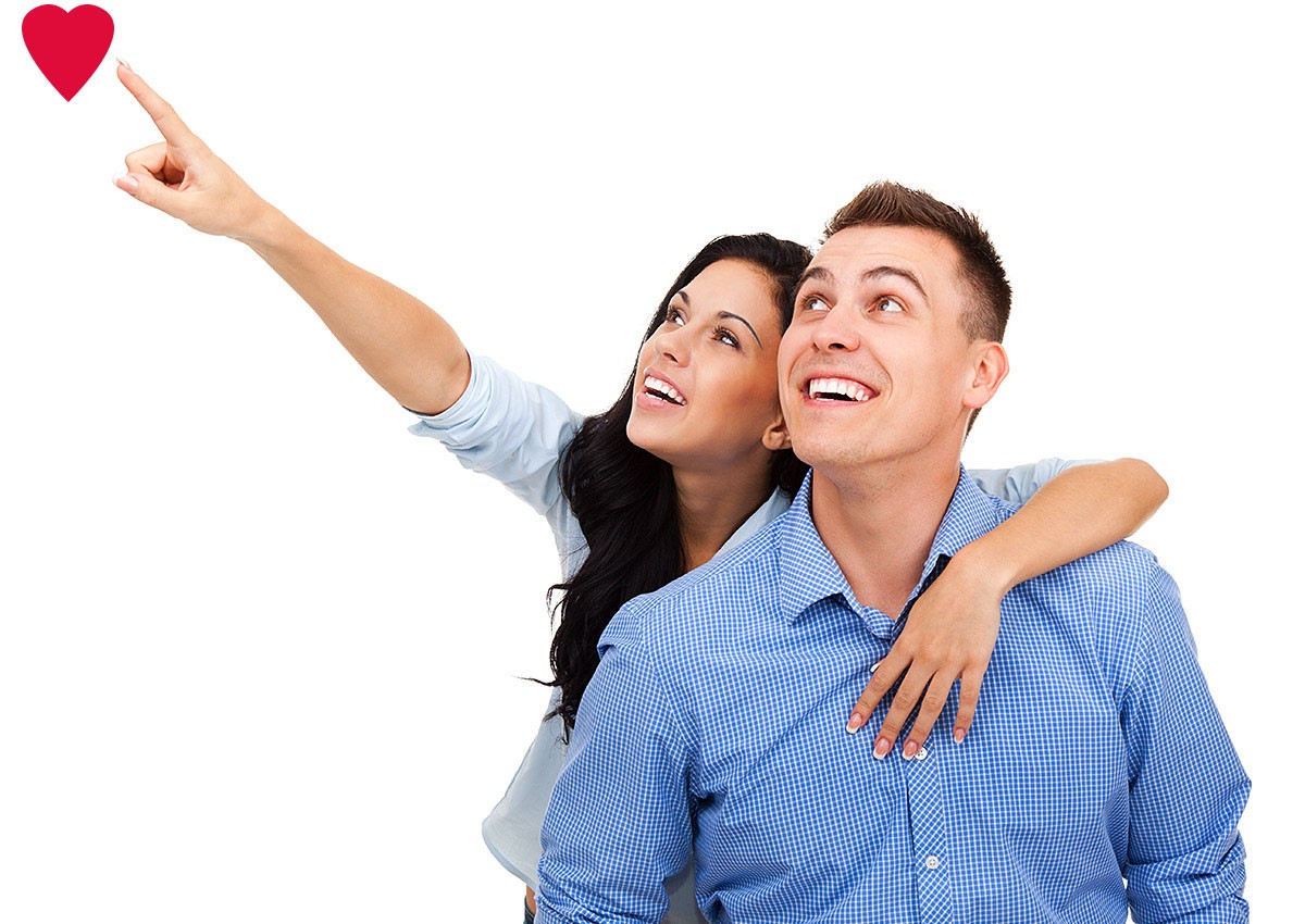 Happy couple shows a red heart of love