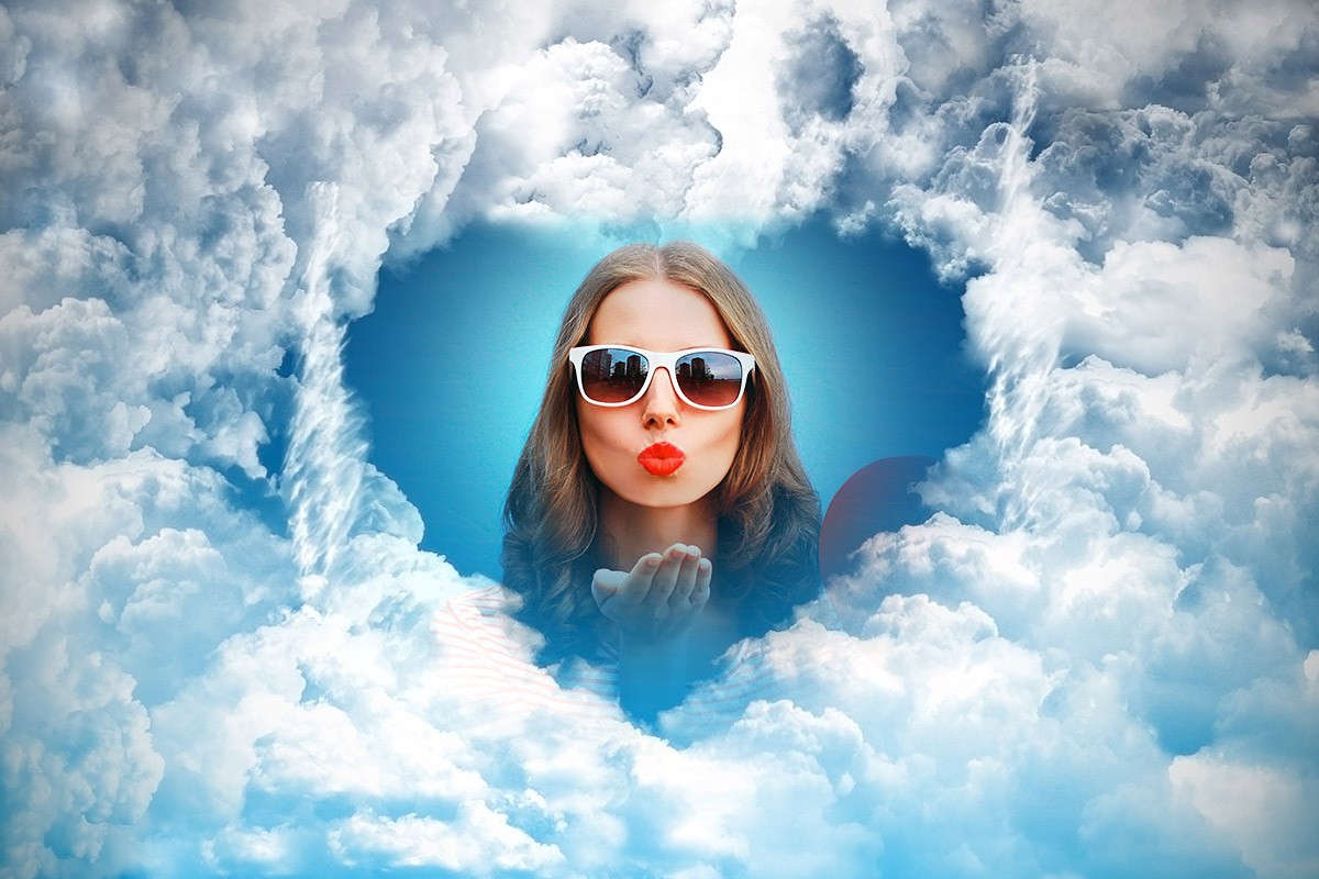 Image of clouds in the form of a heart and in the center the face of a girl