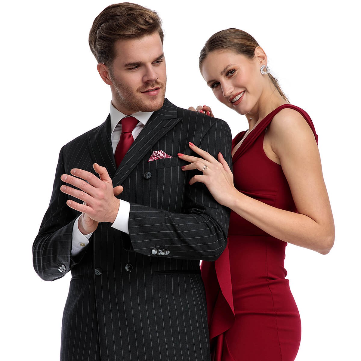 Attractive man in a suit with a pretty woman in a beautiful red dress