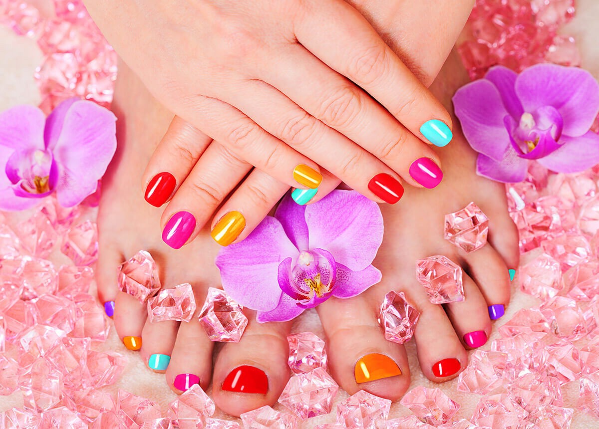 Multicolored pedicure and flowers