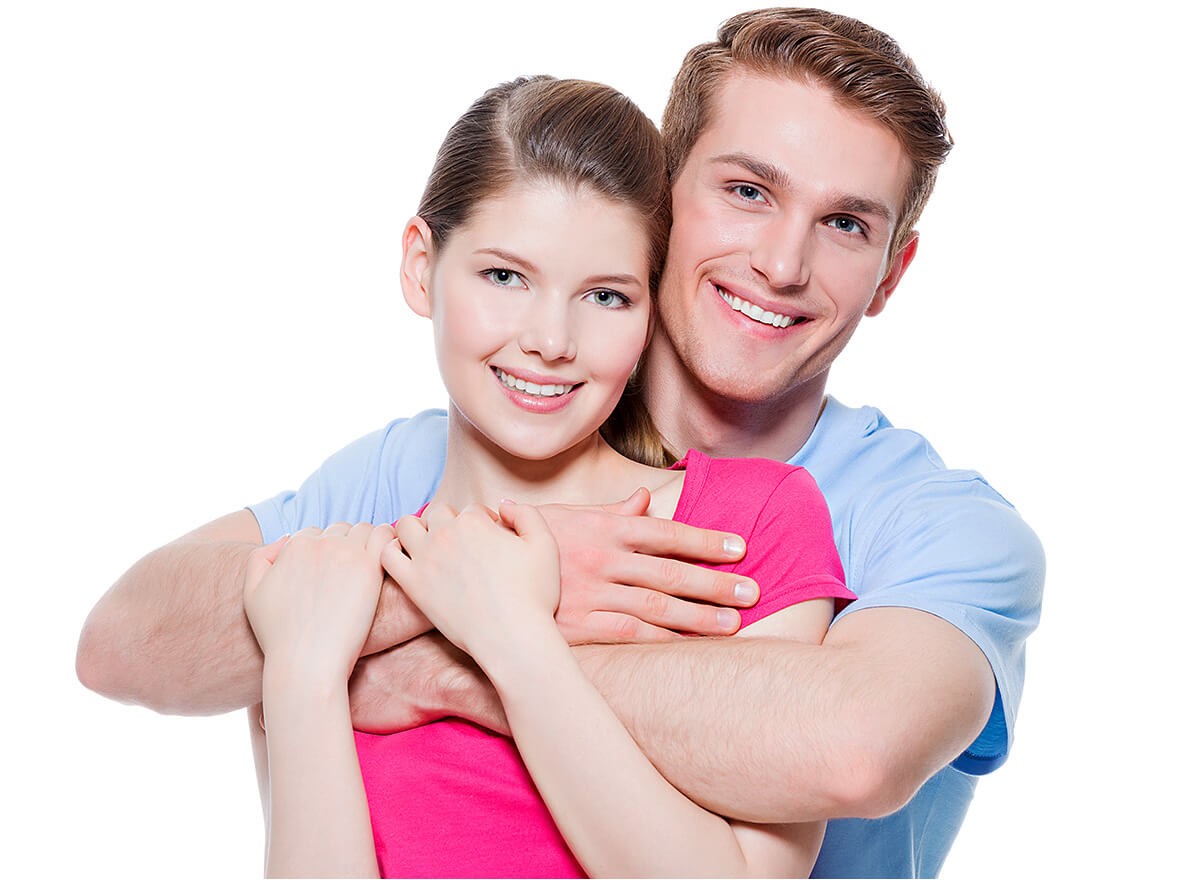 Joyful man hugs his beloved woman