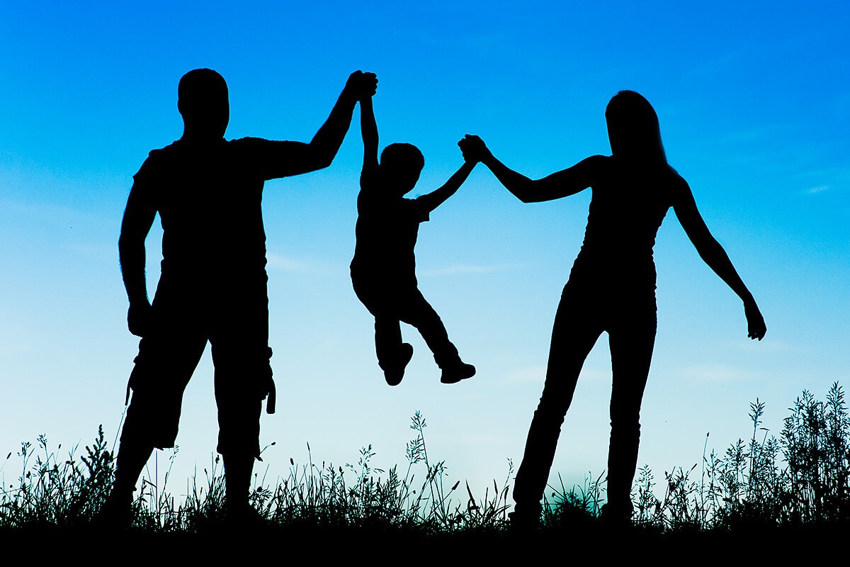 Image of a family and their child in nature