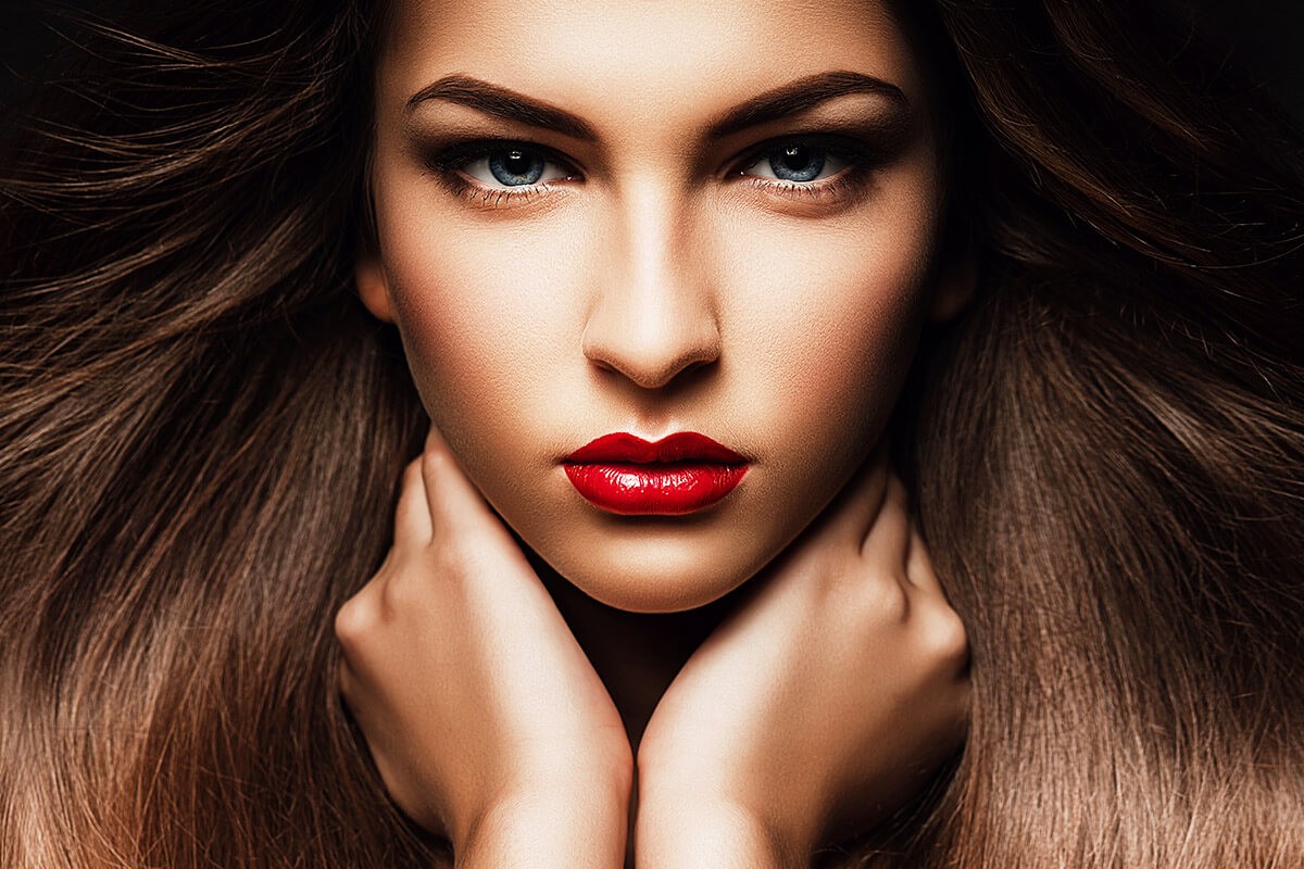 Image of a woman with bright red lipstick and beautiful eyebrows Image of a woman with bright red lipstick and beautiful eyebrows
